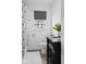 Well-lit bathroom with black vanity, toilet, and patterned shower curtain at 6471 Homestead Dr, Indianapolis, IN 46227
