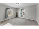 Bright bedroom with neutral carpet, ample natural light from two windows at 6471 Homestead Dr, Indianapolis, IN 46227