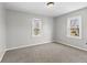 Neutral bedroom with two windows and neutral carpet features views of the yard at 6471 Homestead Dr, Indianapolis, IN 46227