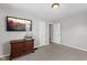 Bedroom with neutral carpet, wooden dresser, and wall-mounted television at 6471 Homestead Dr, Indianapolis, IN 46227
