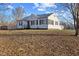 Well-kept home with a detached garage and a peaceful, grassy lawn at 6471 Homestead Dr, Indianapolis, IN 46227