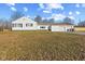 Rear view of a home with a detached two-car garage and well-maintained lawn at 6471 Homestead Dr, Indianapolis, IN 46227