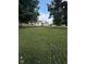 Well-maintained front yard showcasing the home with mature trees in a serene setting at 6471 Homestead Dr, Indianapolis, IN 46227