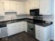 Kitchen with white cabinets, stainless steel appliances, and marble backsplash at 709 Andrea Dr, Beech Grove, IN 46107