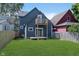 A spacious backyard with lush grass, a wooden deck, and a second-story balcony at 730 Sanders St, Indianapolis, IN 46203