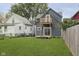 Gray house with deck and grassy backyard, wooden fence, and neighboring houses at 730 Sanders St, Indianapolis, IN 46203
