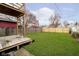 Large backyard with wooden deck and fence at 730 Sanders St, Indianapolis, IN 46203