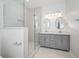 Modern bathroom with double vanity, large mirror, and glass shower at 730 Sanders St, Indianapolis, IN 46203