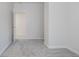 Small bedroom with grey carpet and access to another room at 730 Sanders St, Indianapolis, IN 46203