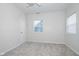 Simple bedroom with grey carpet and a window at 730 Sanders St, Indianapolis, IN 46203