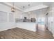 Open concept dining area with hardwood floors and kitchen island at 730 Sanders St, Indianapolis, IN 46203