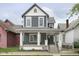Two-story gray house with white trim, front porch, and landscaping at 730 Sanders St, Indianapolis, IN 46203