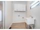 Bright laundry room with white cabinets and vinyl flooring at 730 Sanders St, Indianapolis, IN 46203