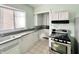 Kitchen features white cabinets, stainless steel appliances, and a bay window at 78 N Belleview Pl, Indianapolis, IN 46222