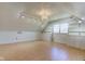 Light-filled attic space featuring built-in storage, natural light, and wood flooring at 8116 E 900 N, Wilkinson, IN 46186