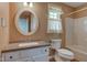 Traditional bathroom with white vanity, oval mirror, and tub/shower combo at 8116 E 900 N, Wilkinson, IN 46186