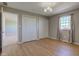 Bedroom with hardwood floors, closet, and large window with floral curtains at 8116 E 900 N, Wilkinson, IN 46186