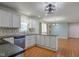 Bright kitchen featuring white cabinets, stainless steel appliances, and an open layout connecting to other living areas at 8116 E 900 N, Wilkinson, IN 46186