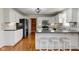 Modern kitchen with stainless steel appliances, granite countertops, white cabinets, and a convenient breakfast bar at 8116 E 900 N, Wilkinson, IN 46186