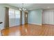 Cozy living room with wood floors, a stylish chandelier, and a large window offering plenty of natural light at 8116 E 900 N, Wilkinson, IN 46186