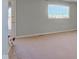 Spacious living room with neutral carpet and bright natural light from a large window at 8116 E 900 N, Wilkinson, IN 46186