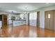 Open-concept living area with a kitchen island, wood floors, white cabinetry, and a view to the front entrance at 8116 E 900 N, Wilkinson, IN 46186