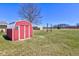 Storage shed in grassy backyard with bare trees in background at 8116 E 900 N, Wilkinson, IN 46186