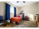 Stylish bedroom featuring a twin bed, red bedding, and a travel-themed wall at 8325 Anemone Ln, Indianapolis, IN 46219