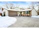 Updated ranch home with rocking chairs on the porch, new garage door and landscaping at 8325 Anemone Ln, Indianapolis, IN 46219