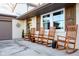 Charming front porch with four rocking chairs, adding to the home's curb appeal at 8325 Anemone Ln, Indianapolis, IN 46219