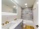 Modern bathroom with gray tile, dual sinks, and a bathtub at 1306 E Minnesota St, Indianapolis, IN 46203