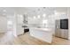 Modern white kitchen with center island, stainless steel appliances, and quartz countertops at 1306 E Minnesota St, Indianapolis, IN 46203