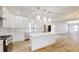 Modern white kitchen with center island, stainless steel appliances, and quartz countertops at 1306 E Minnesota St, Indianapolis, IN 46203