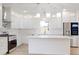 Modern white kitchen with center island, stainless steel appliances, and quartz countertops at 1306 E Minnesota St, Indianapolis, IN 46203