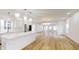 Open concept kitchen and dining area with stainless steel appliances and light wood floors at 1306 E Minnesota St, Indianapolis, IN 46203