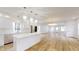 Open concept kitchen and dining area with stainless steel appliances and light wood floors at 1306 E Minnesota St, Indianapolis, IN 46203