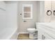 Clean bathroom, featuring a white vanity, toilet and bathtub at 1415 N Pershing Ave, Indianapolis, IN 46222