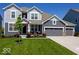 Two-story house with gray siding, three-car garage, and landscaped lawn at 15998 Bugle Ridge Dr, Noblesville, IN 46060