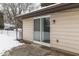 Back patio with sliding glass doors and snow at 1611 Vineyard Ct, Indianapolis, IN 46260