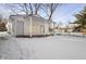 Cozy white bungalow with covered porch and snowy yard at 1628 Beulah Ave, Indianapolis, IN 46241