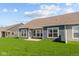 Expansive back exterior featuring a lush green lawn, concrete patio, and lots of natural light at 16673 Cattle Hollow Ln, Noblesville, IN 46060