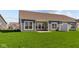 Back exterior view of a single Gathering home, featuring a lush green lawn and lots of natural light at 16673 Cattle Hollow Ln, Noblesville, IN 46060