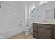 Bathroom with a shower and tub combo, featuring a vanity and an accent window, providing a bright space at 16673 Cattle Hollow Ln, Noblesville, IN 46060