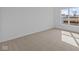 Bright, carpeted bedroom featuring a large window for natural light, freshly painted white walls, and spacious room at 16673 Cattle Hollow Ln, Noblesville, IN 46060