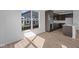 Modern kitchen featuring dark cabinets, stainless steel appliances, and bright natural light from a large window at 16673 Cattle Hollow Ln, Noblesville, IN 46060
