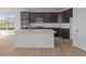 Modern kitchen featuring a center island, dark cabinetry, stainless appliances, and wood flooring at 16673 Cattle Hollow Ln, Noblesville, IN 46060