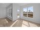 Bright sunroom featuring large windows, allowing an abundance of natural light, and modern vinyl flooring at 16673 Cattle Hollow Ln, Noblesville, IN 46060