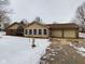 Ranch home with attached two-car garage and snow at 17 Riverview Dr, Anderson, IN 46012