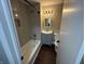 Clean bathroom, featuring a bathtub, gray vanity, and dark flooring at 1801 W Morris St, Indianapolis, IN 46221