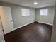 Well-lit bedroom, showcasing dark brown flooring and two windows at 1801 W Morris St, Indianapolis, IN 46221